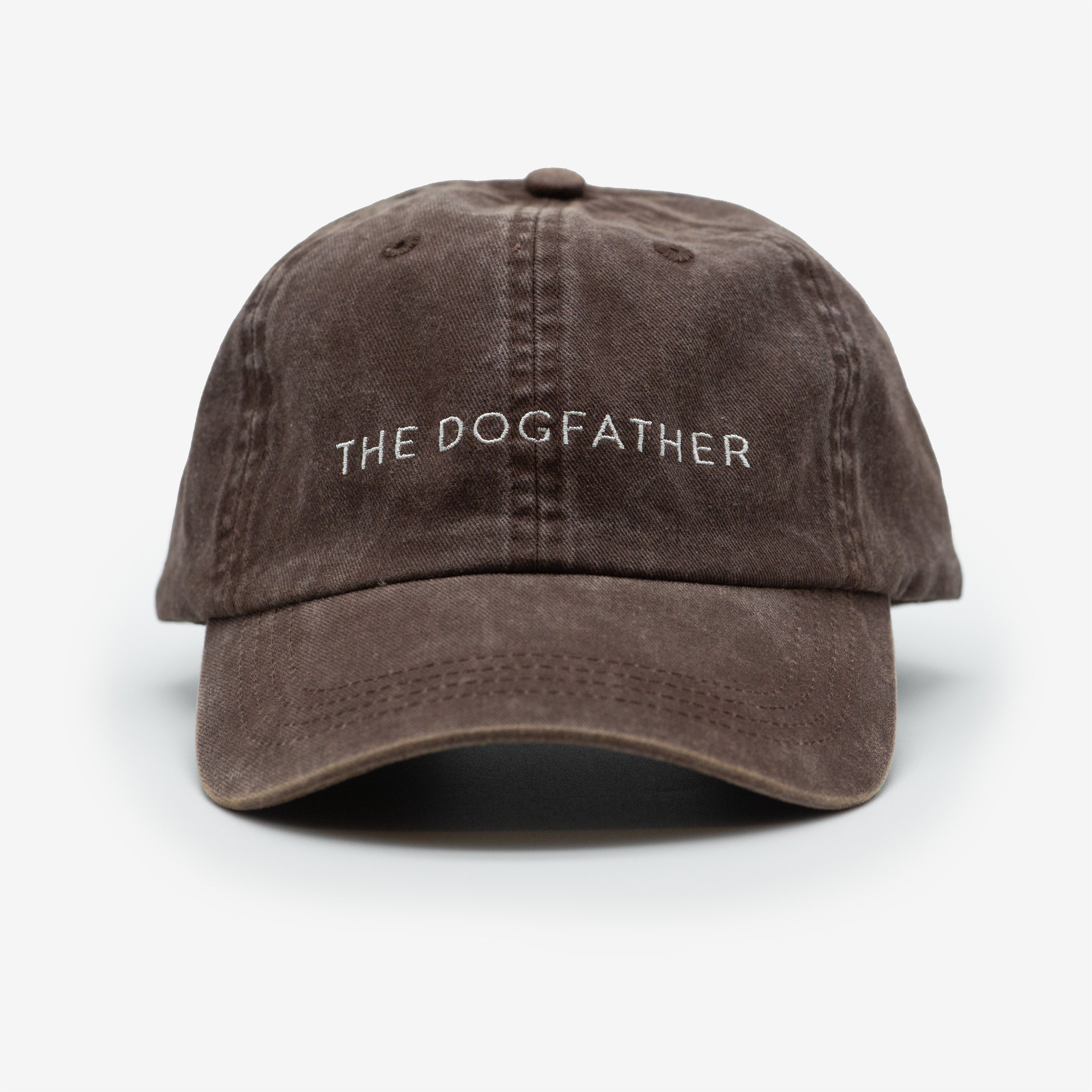 A brown denim cap with the text 'THE DOGFATHER' embroidered on the front.